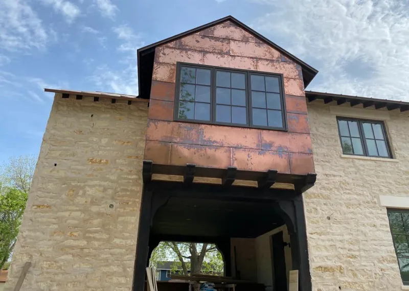 Copper metal panel facade on a stone building for Metal Roof Coating in Independence